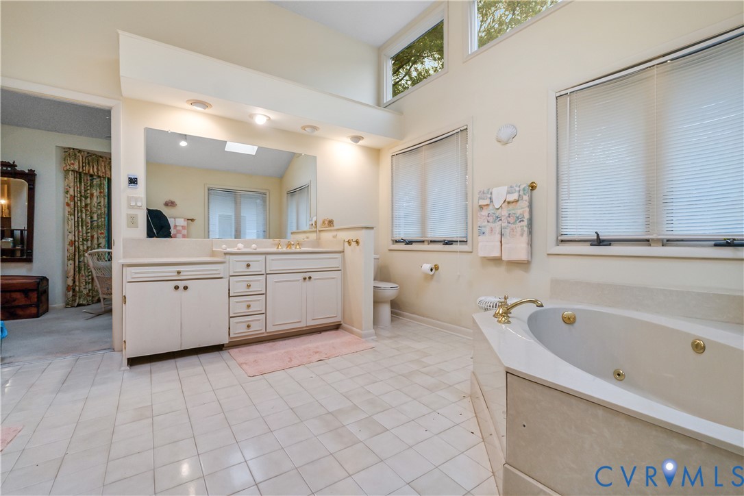 2086 Defense Road Petersburg, VA 23805 - Photo 29 of 32 Full bathroom with a jetted tub, vanity, light til