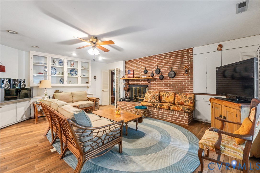 2086 Defense Road Petersburg, VA 23805 - Photo 9 of 32 Living room featuring wood-type flooring, a brick