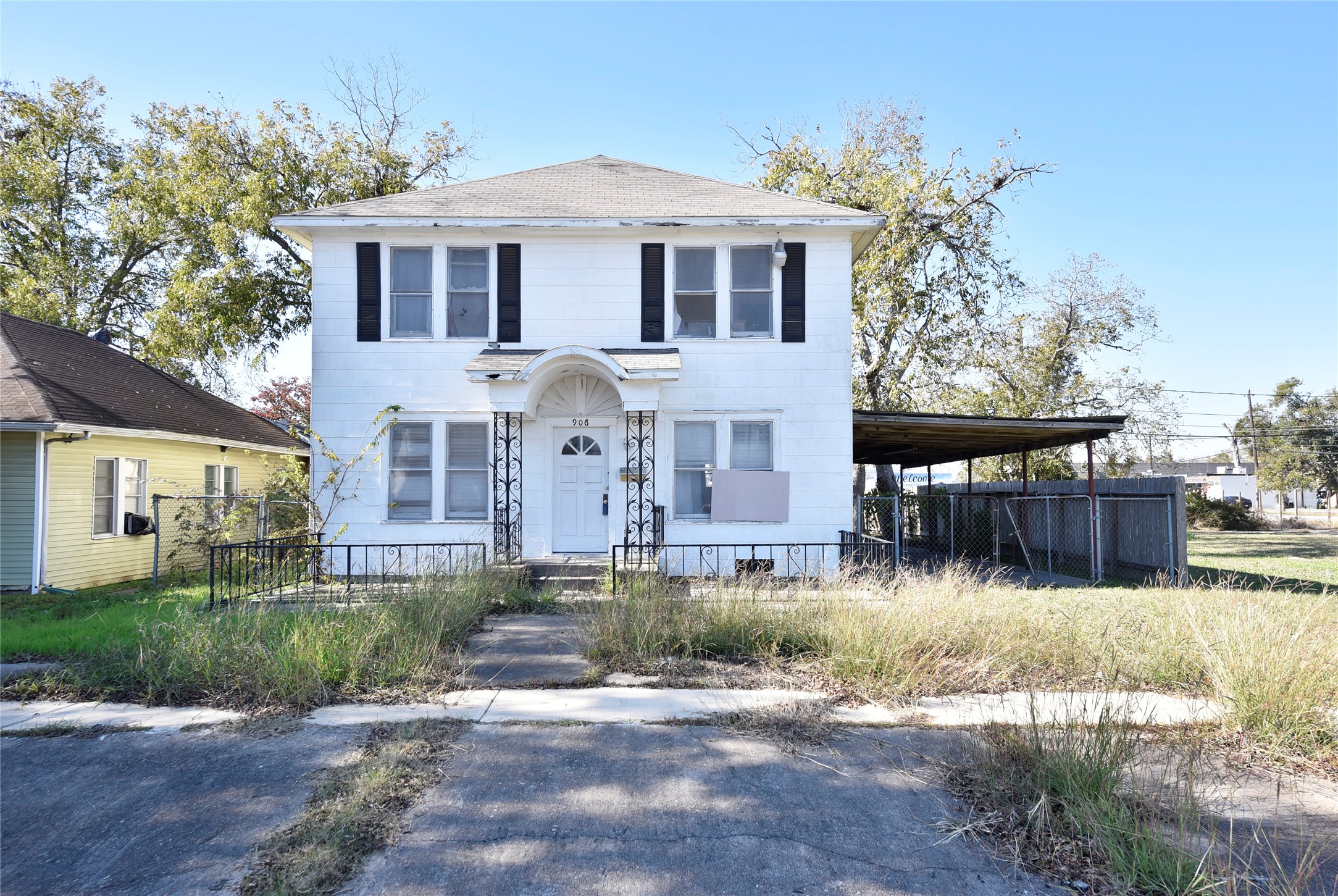 a front view of a house with a yard and potted plants