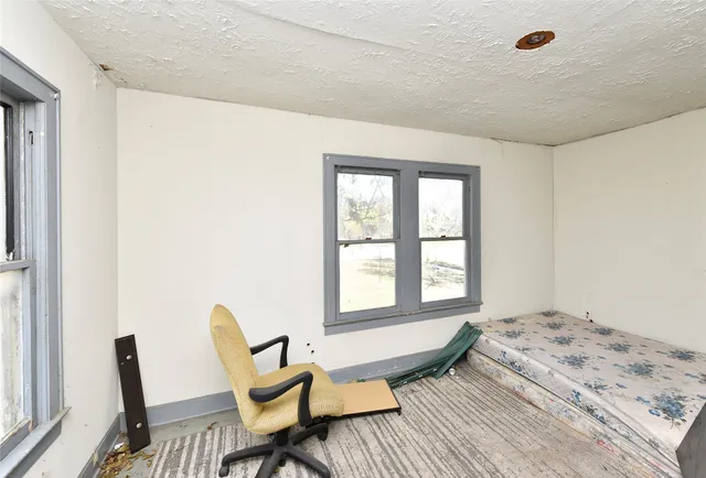 a bedroom with a bed and a chair