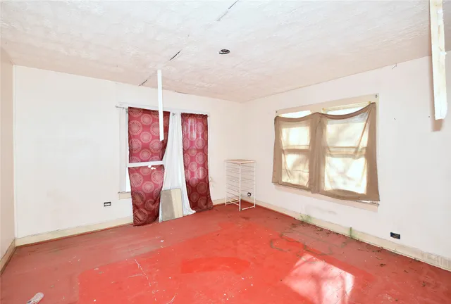 a view of a room with window and a ceiling fan