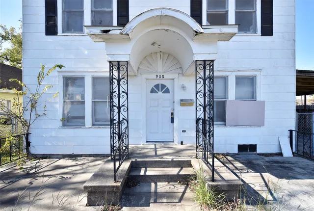 a front view of house with yard and outdoor seating