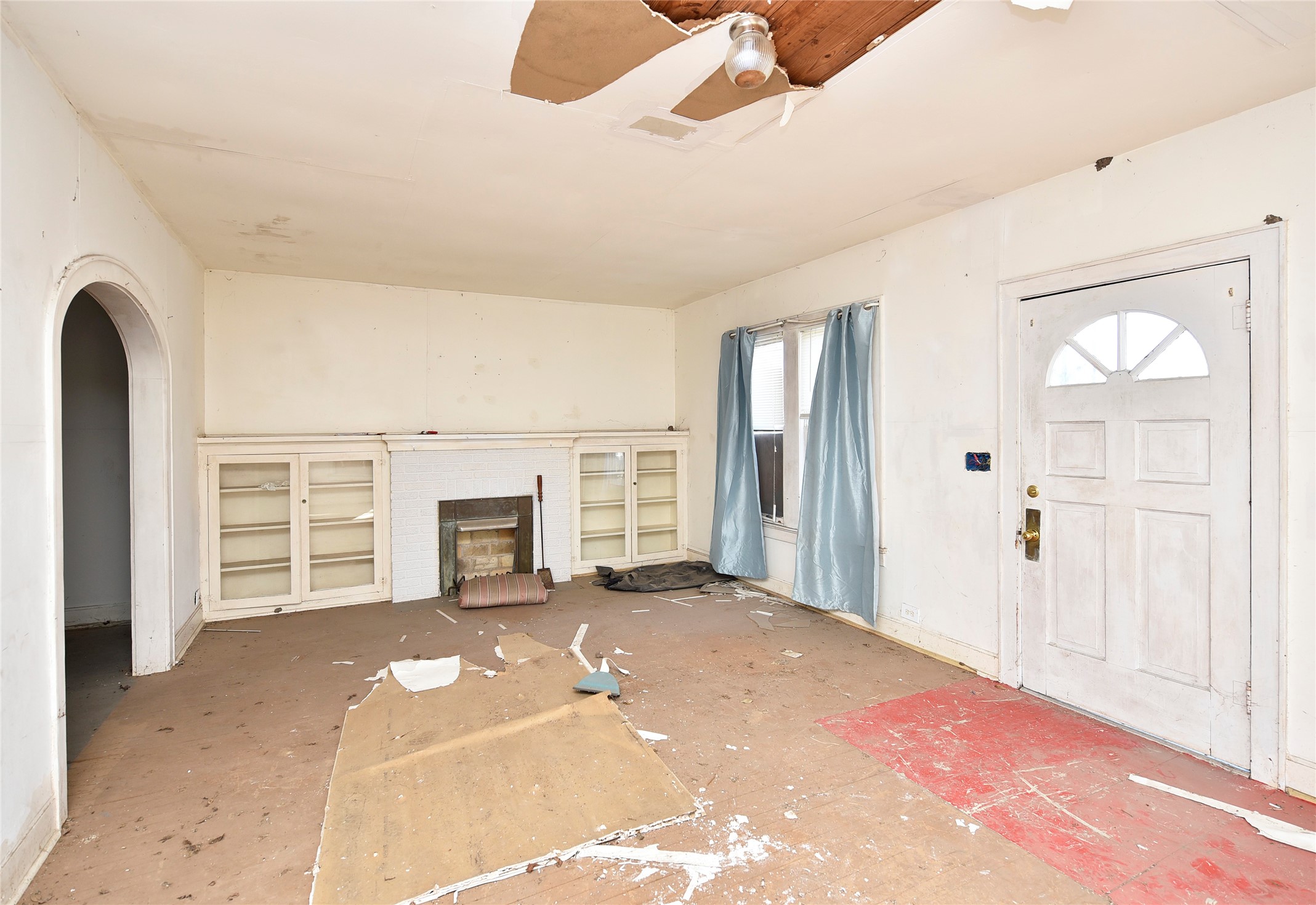 908 6th Street Rosenberg, TX 77471 - Photo 8 of 34 a view of a livingroom with a fireplace cabinet and windows