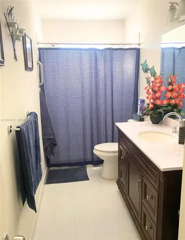 a bathroom with a sink a toilet and a tub