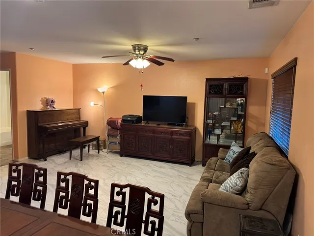 a view of a hallway with wooden floor and a bathroom