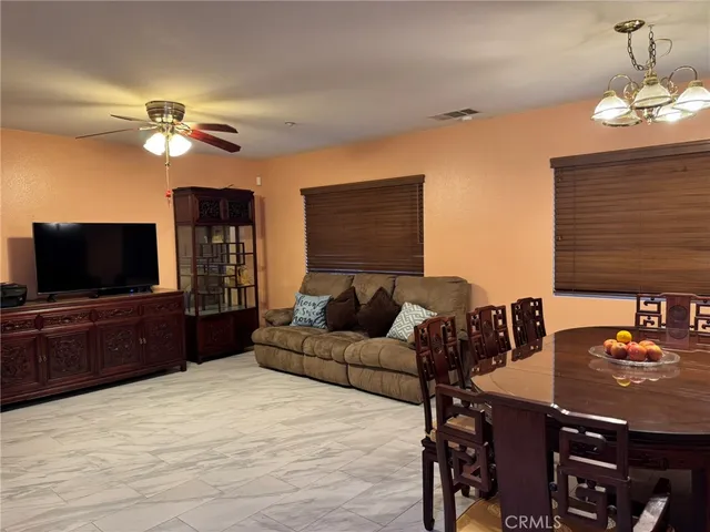 a view of a dining room with furniture and chandelier