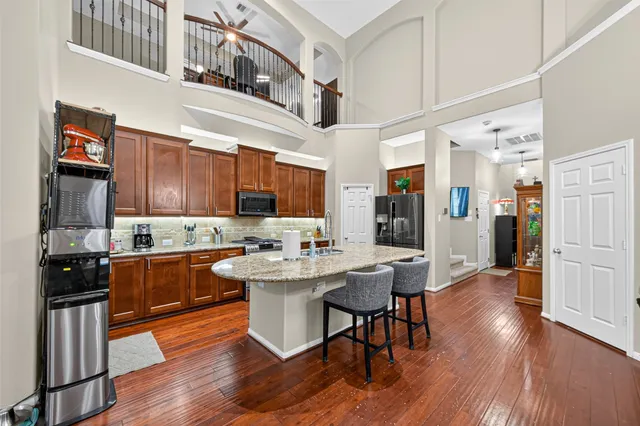 a kitchen with stainless steel appliances granite countertop a stove and cabinets