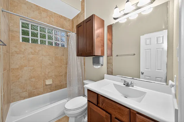 a bathroom with a sink toilet tub and shower