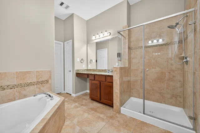 a bathroom with a tub shower and sink
