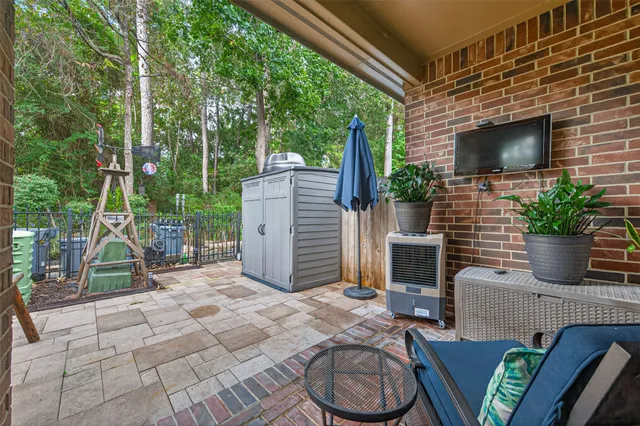 a building outdoor space with patio furniture and potted plants