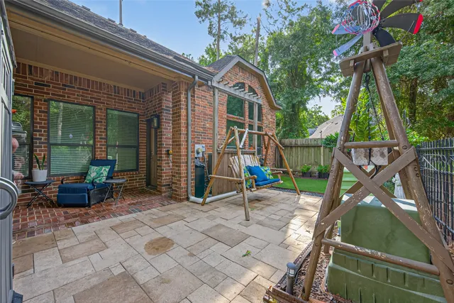 a view of a house with a backyard and a patio