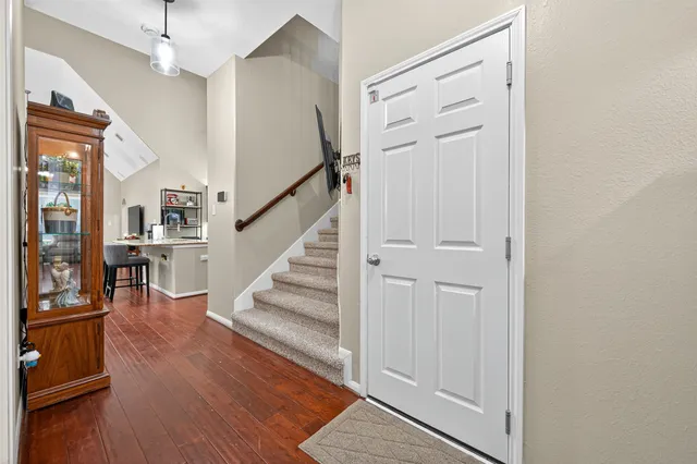 a view of entryway and hall with wooden floor