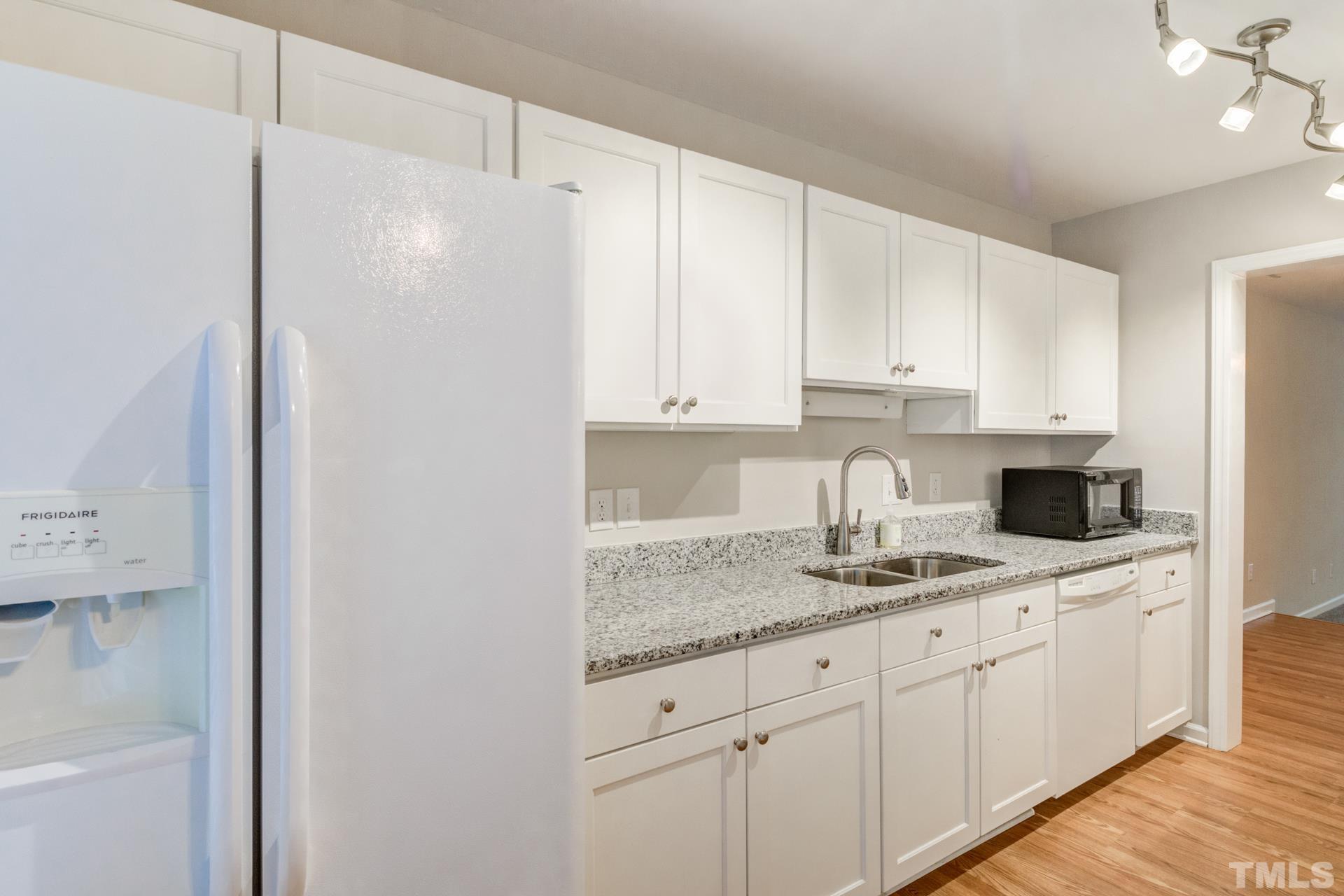 4205 Sunscape Lane Raleigh, NC 27613 - Photo 4 of 23 New granite in this gorgeous galley style kitchen.
