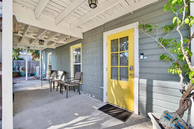 a view of a patio with table and chairs