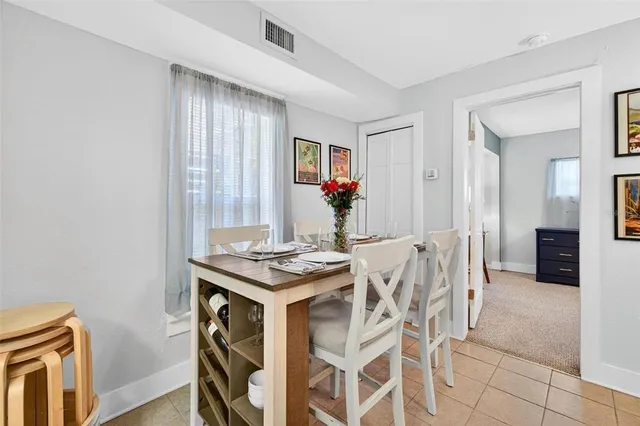 a view of a dining room with furniture and window