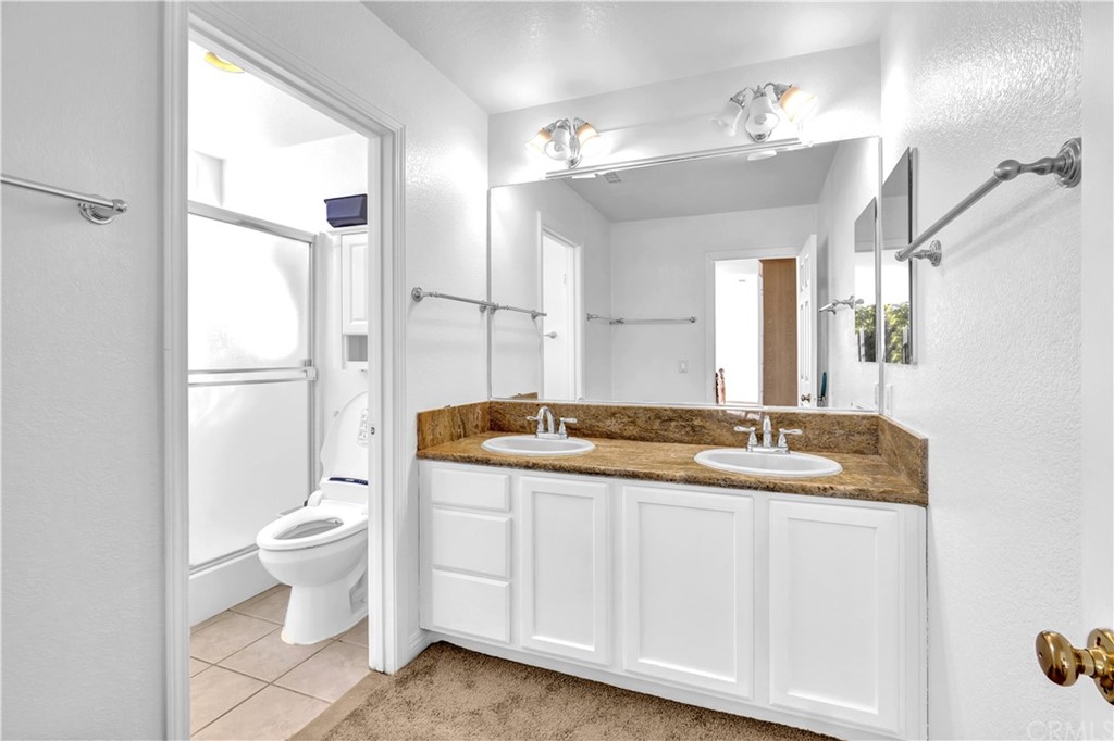 19366 Fortune Place Rowland Heights, CA 91748 - Photo 20 of 32 a bathroom with a granite countertop sink mirror vanity and toilet