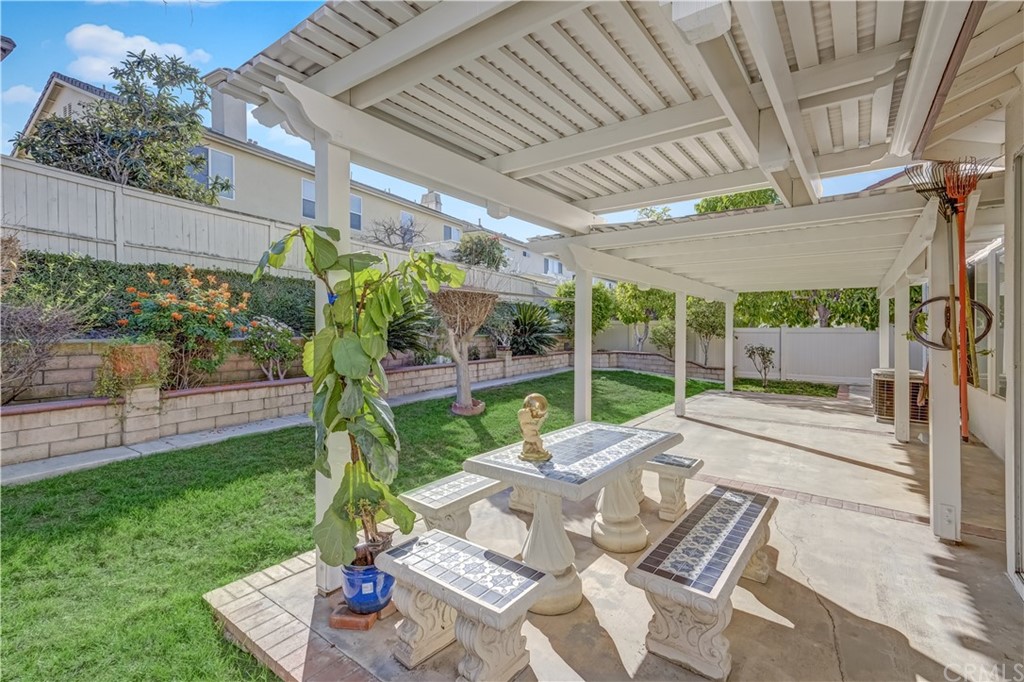 19366 Fortune Place Rowland Heights, CA 91748 - Photo 25 of 32 a view of a patio with table and chairs potted plants with wooden floor and fence