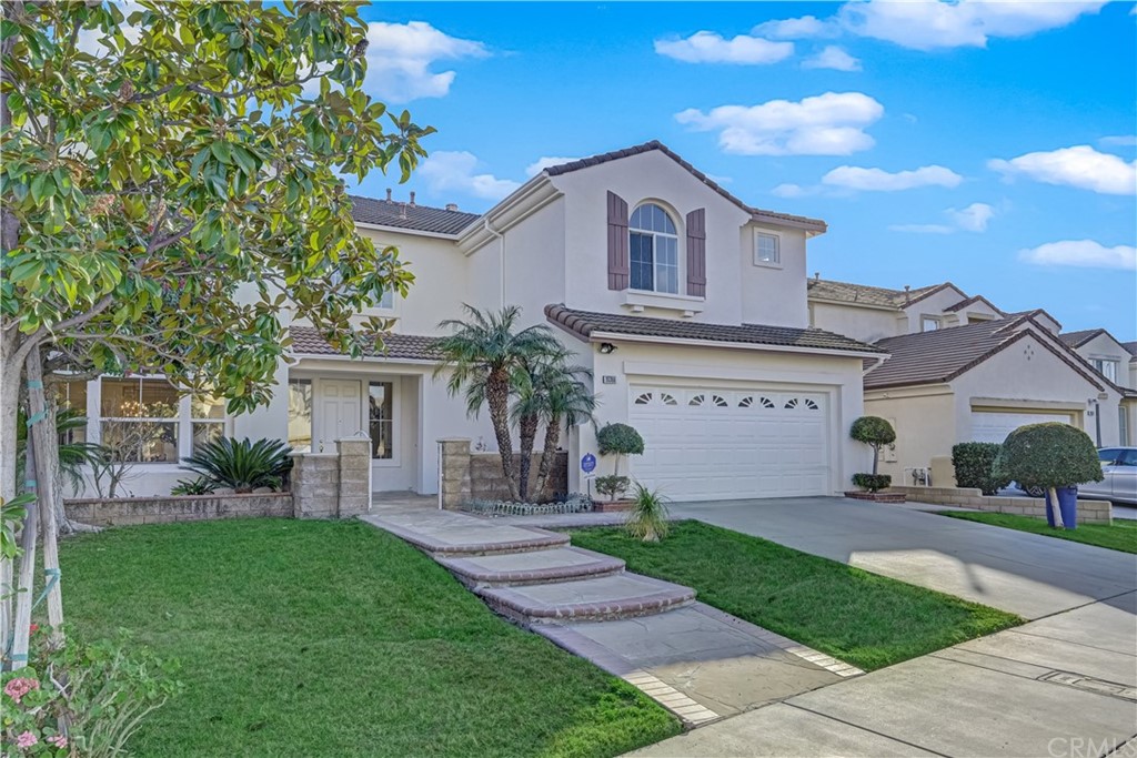 19366 Fortune Place Rowland Heights, CA 91748 - Photo 3 of 32 a front view of a house with a garden and plants
