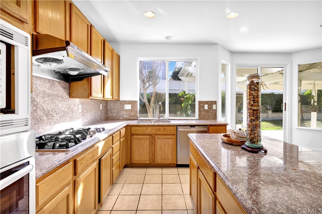 19366 Fortune Place Rowland Heights, CA 91748 - Photo 7 of 32 a kitchen with stainless steel appliances granite countertop a stove a sink and a microwave