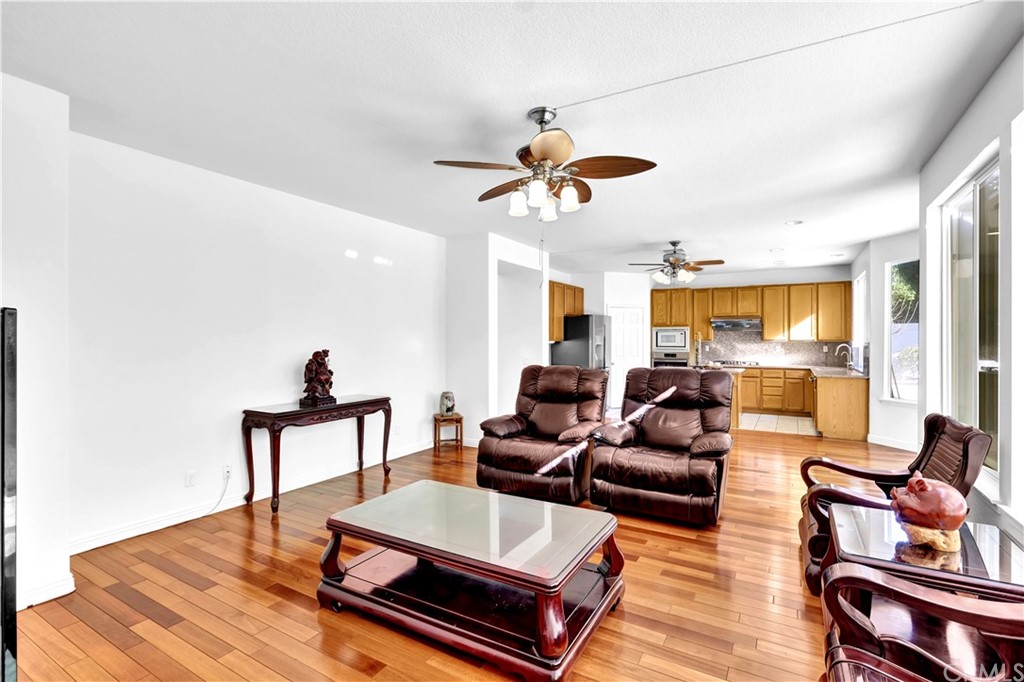 19366 Fortune Place Rowland Heights, CA 91748 - Photo 8 of 32 a living room with furniture ceiling fan and a rug