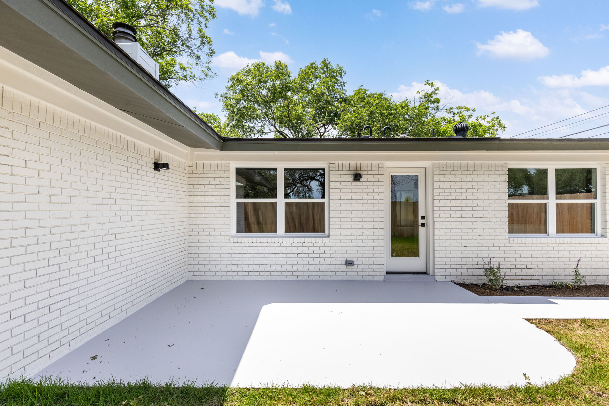 4501 Pack Saddle Pass Austin, TX 78745 - Photo 32 of 37 Spacious concrete patio with white-painted brick exterior
