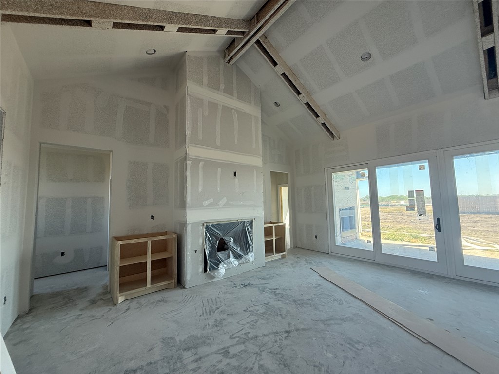 1501 Mariposa Ranch Corpus Christi, TX 78413 - Photo 2 of 4 a view of a livingroom with a fireplace and window