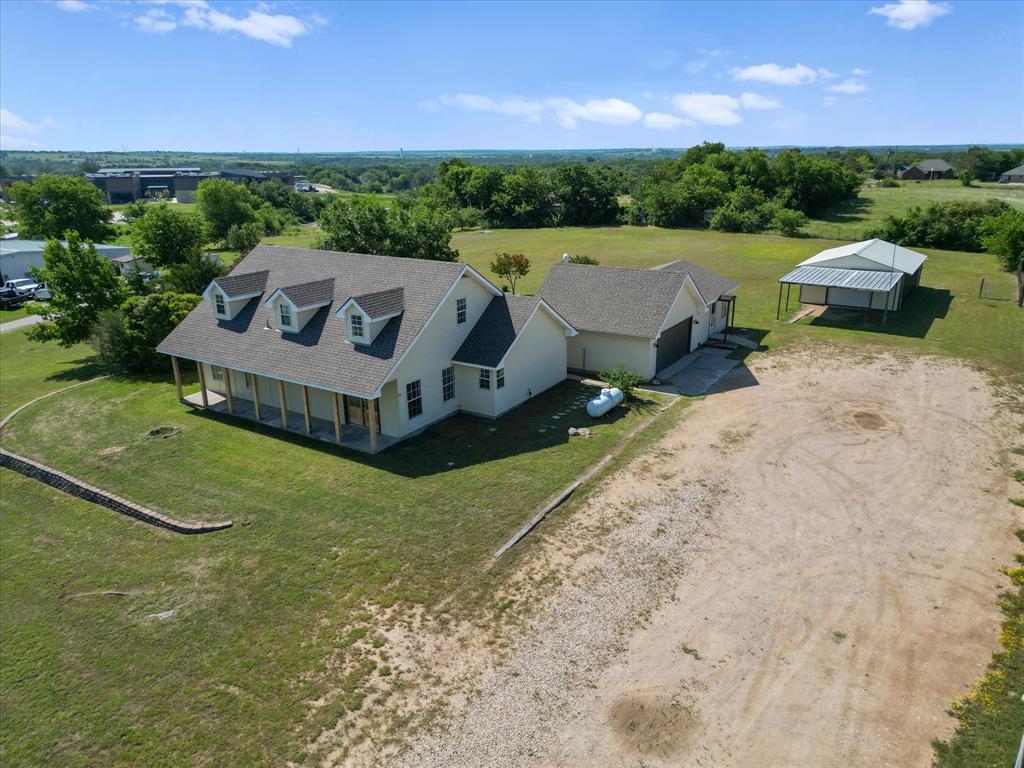 289 County Road 4655 Rhome, TX 76078 - Photo 27 of 34 Cream-colored exterior with a covered front porch featuring multiple support columns