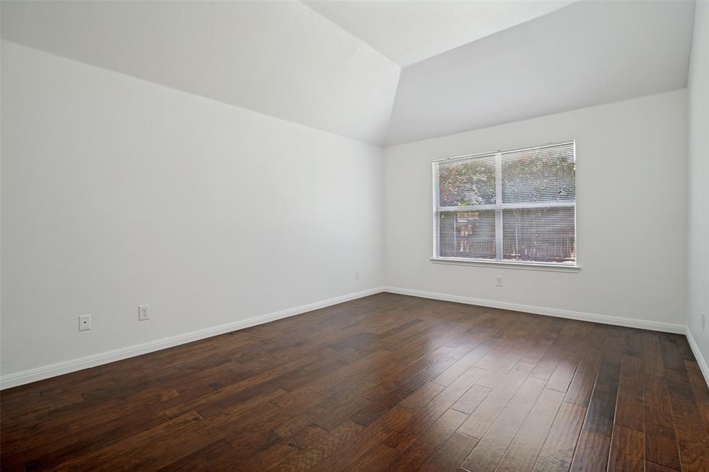 3111 Creekside Drive Sachse, TX 75048 - Photo 14 of 25 Vaulted ceiling room with wood-finish flooring, white baseboards, and a large multi-pane window