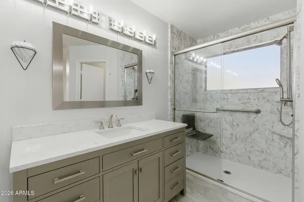 a bathroom with a double vanity sink toilet and shower