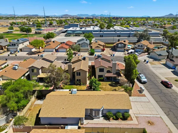an aerial view of residential houses with outdoor space