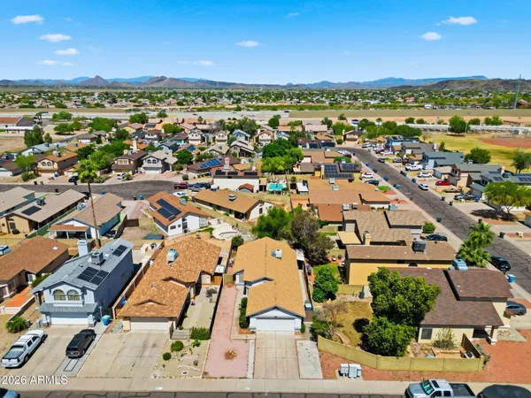 an aerial view of residential houses with outdoor space
