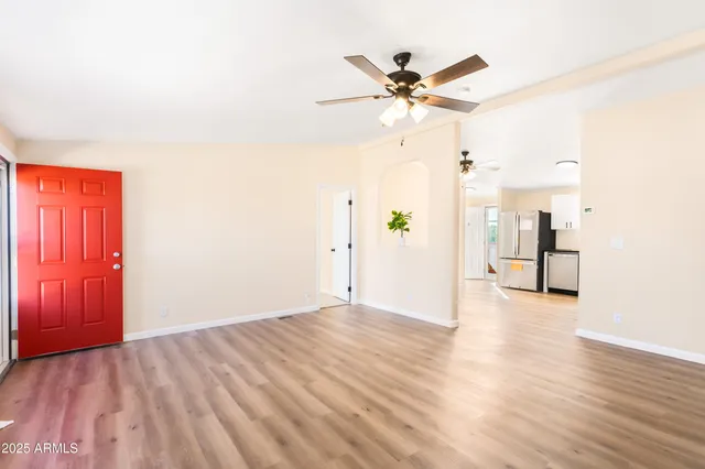 a view of empty room with wooden floor