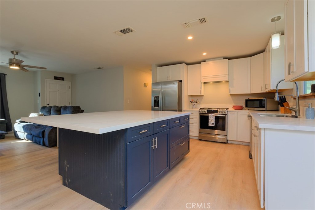 1274 Filbert Avenue Chico, CA 95926 - Photo 12 of 52 a kitchen with stainless steel appliances a sink a counter top space cabinets and a center island