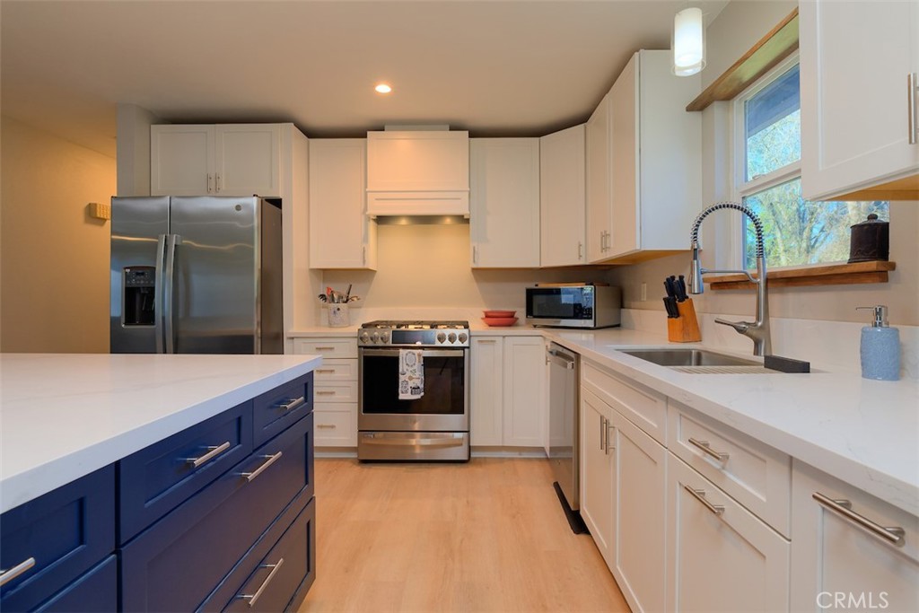 1274 Filbert Avenue Chico, CA 95926 - Photo 13 of 52 a kitchen with stainless steel appliances a refrigerator sink and cabinets