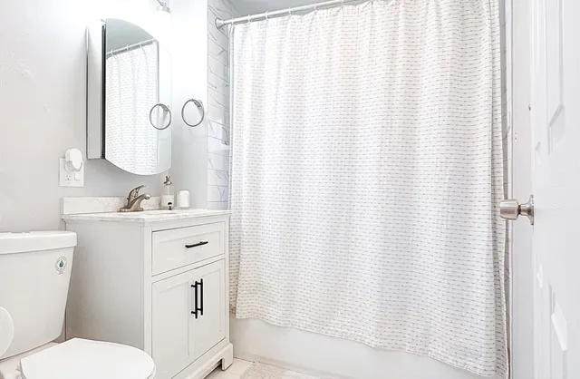 a white toilet sitting next to a bathroom sink