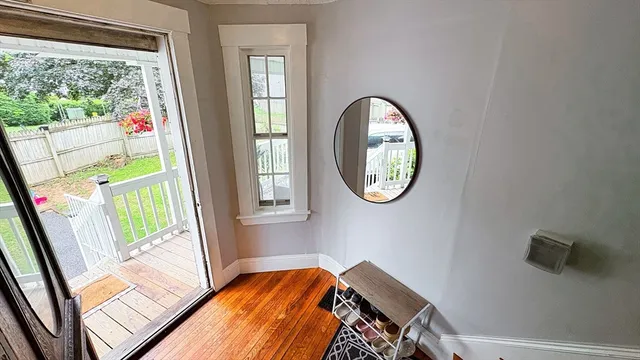 a view of a bedroom with wooden floor and windows