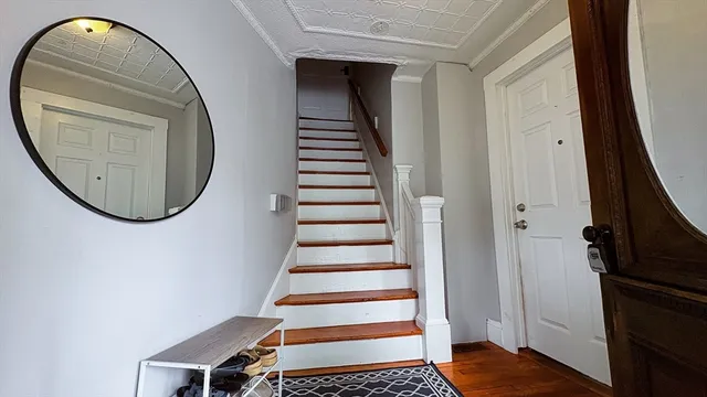an entryway in wooden floor with a living room