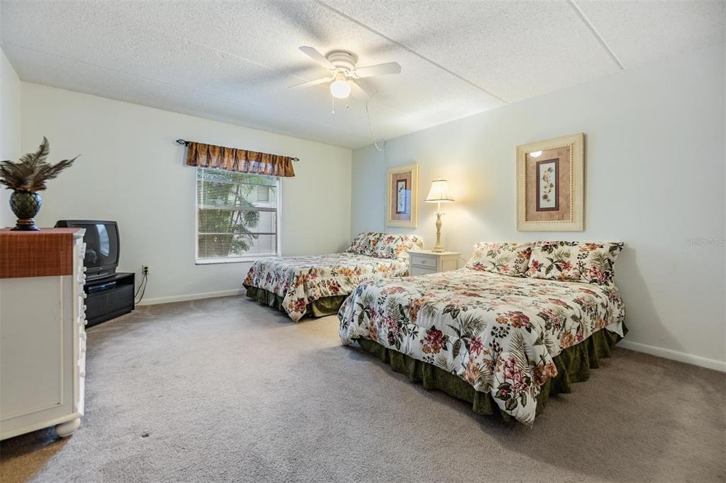 12760 Indian Rocks Road, Unit 104 Largo, FL 33774 - Photo 19 of 37 a spacious bedroom with two bed and a window