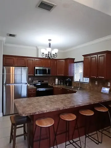 a kitchen with granite countertop a counter space a sink and appliances