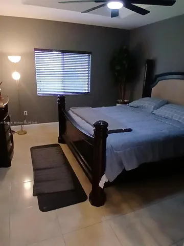a bed sitting in a room next to a window