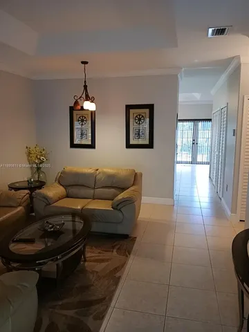 a living room with furniture and a ceiling fan