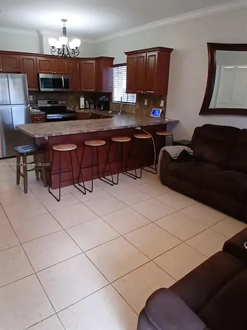 a kitchen with a sink a microwave and a counter top space
