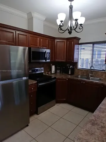 a kitchen with a refrigerator and a sink