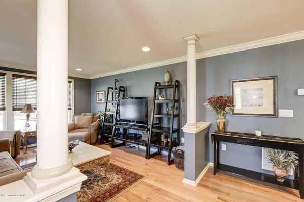 a living room with furniture a piano and a flat screen tv