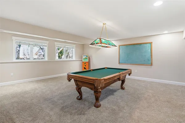 a view of a dining room with furniture a chandelier and wooden floor