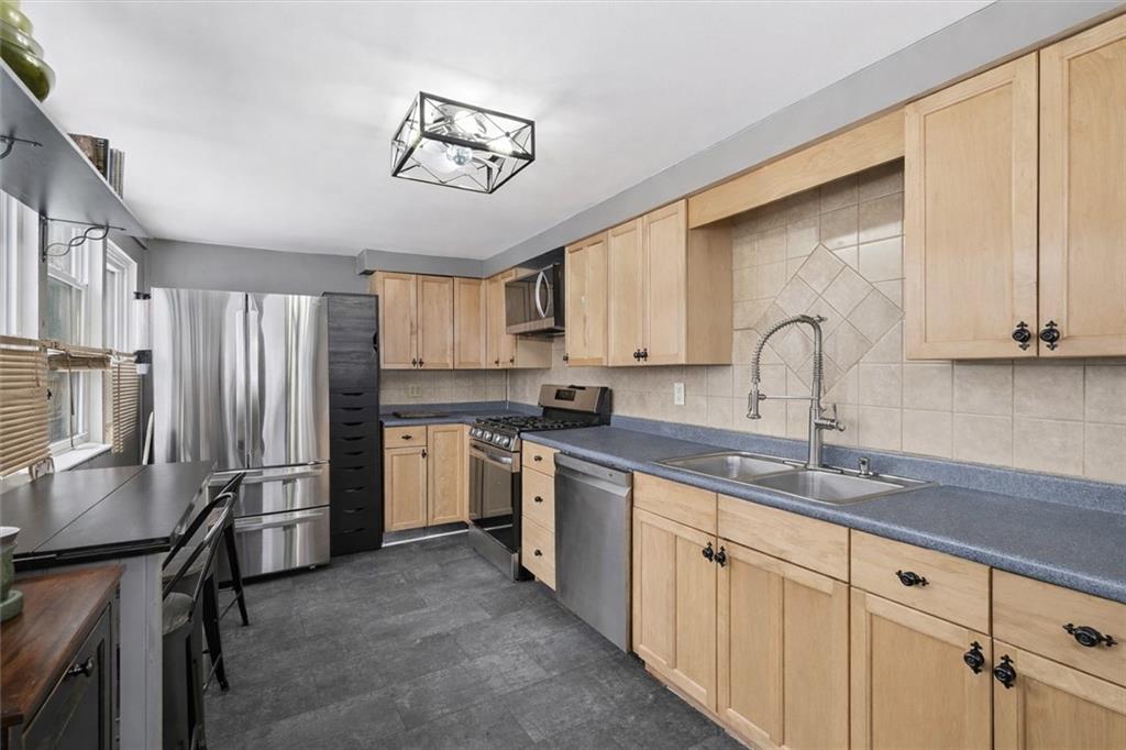 804 Erdner Avenue Pittsburgh, PA 15202 - Photo 12 of 48 a kitchen with refrigerator cabinets and a sink