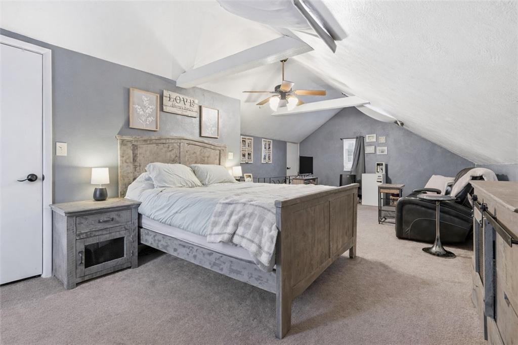 804 Erdner Avenue Pittsburgh, PA 15202 - Photo 23 of 48 a spacious bedroom with a bed and a chandelier