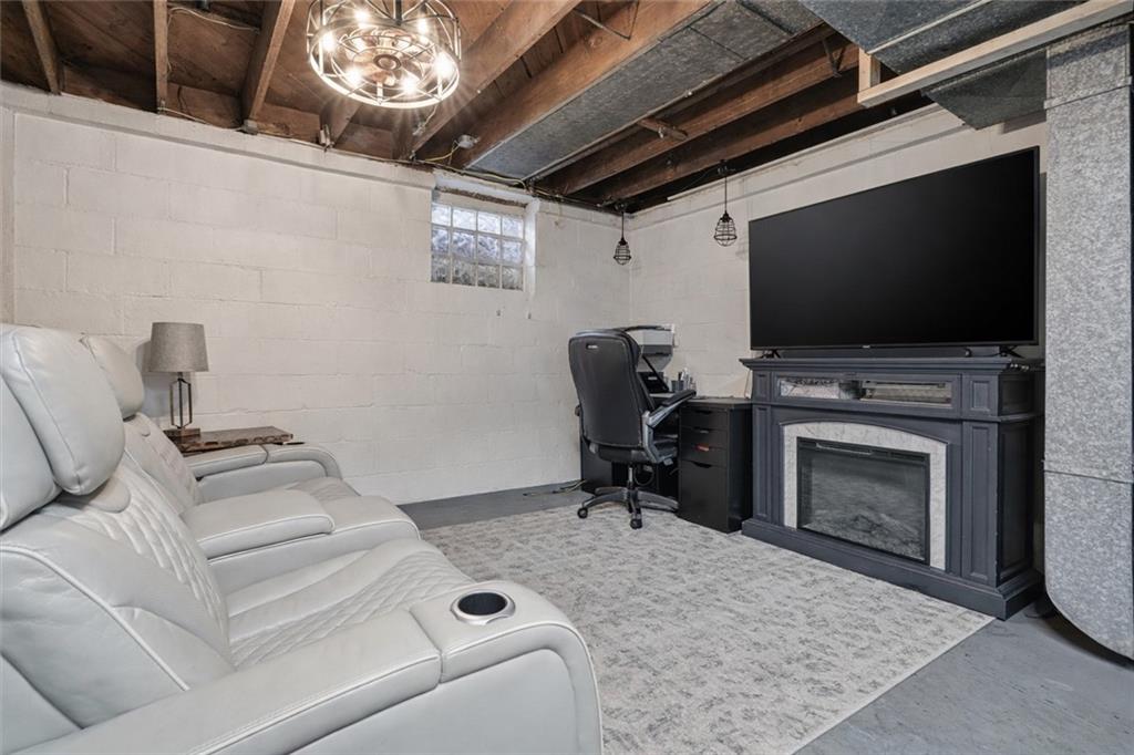 804 Erdner Avenue Pittsburgh, PA 15202 - Photo 27 of 48 a living room with furniture a flat screen tv and a fireplace