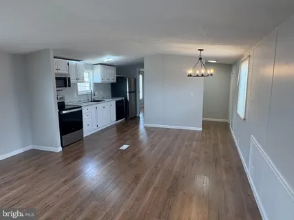 a view of kitchen with sink microwave and refrigerator