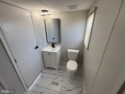 a bathroom with a toilet and a sink